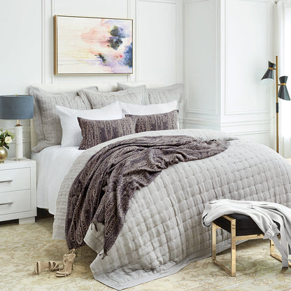 A Danette Quilt displayed on a made bed.