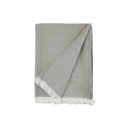 A Declan Ash Bed Throw displayed on a bed.
