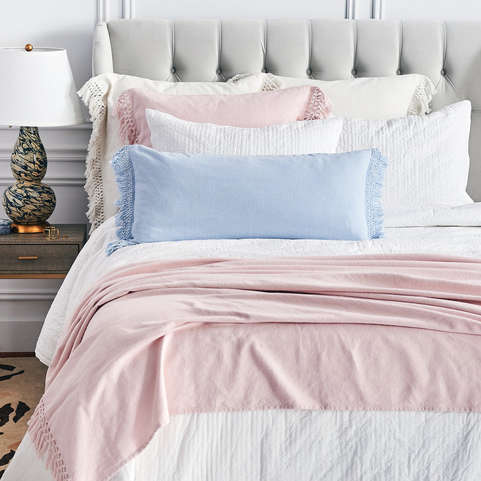 A Lavato Bed Throw displayed on a bed.