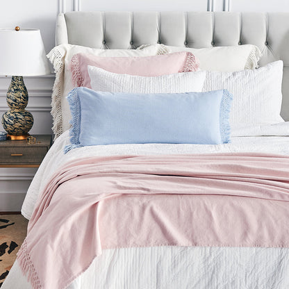 A Lavato Bed Throw displayed on a bed.