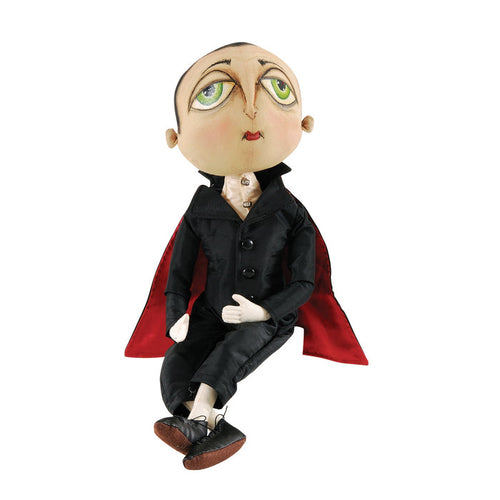 A vampire art doll with a red-lined cape, black suit, and a hand-painted face..