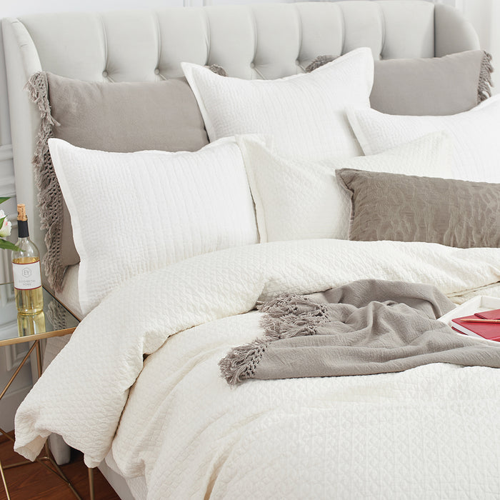 A Pernille Duvet Cover displayed on a bed.