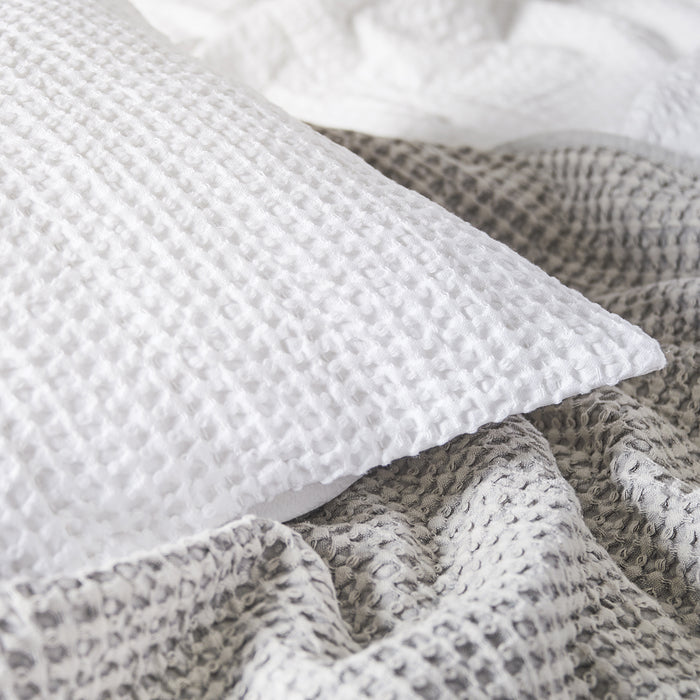 A Waffle Coverlet displayed on a bed.